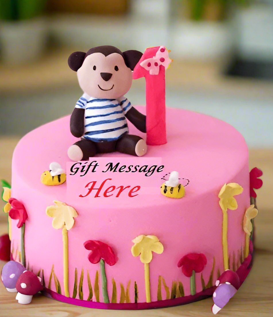 Celebration First Birthday Cake — bright pink-and-yellow first-birthday styling and a small child figure; India