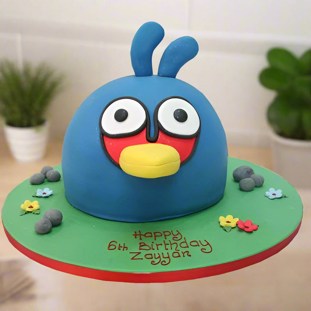 Bird Design Cake — a blue bird character with bright facial details; India