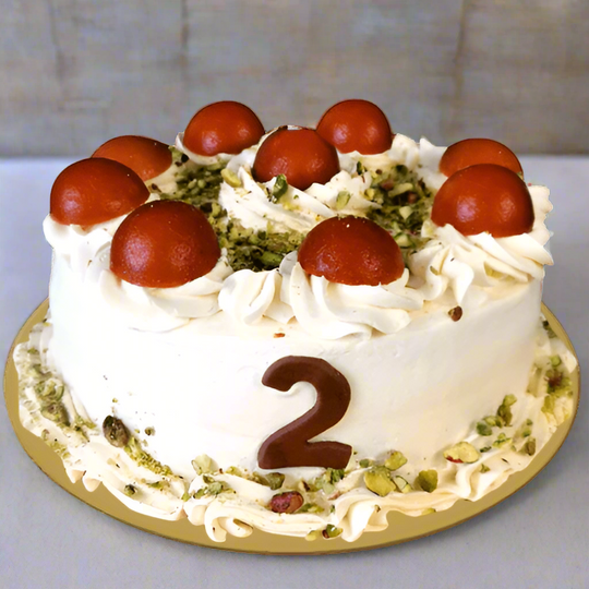 Gulab Jamun Pista Topping Cake - 1 kg — pale cream swirls, round sweet toppings and a number accent; India