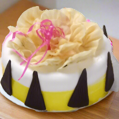 Pineapple Cake for Birthday — white-and-yellow finish with pale flower-style topping; India