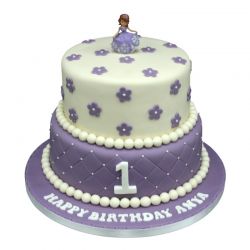 Purple First Birthday Two-Tier Cake — pale-and-purple first-birthday styling with flower motifs; India