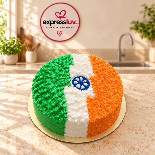 Tricolour India cake with green, white and orange frosting and a blue wheel, photographed on a sunlit marble counter