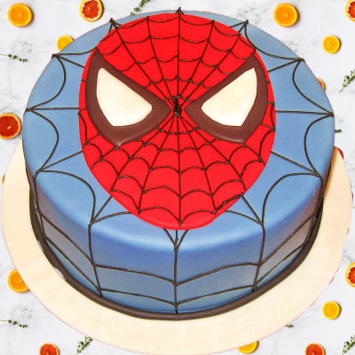 Spider Man Theme Cake — a Spider-Man face with red mask and blue web background; India