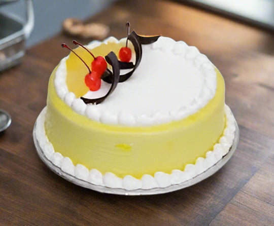 Pineapple Cake for Special Days — yellow sides, white centre and small fruit accents; India