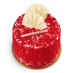 Premium Red Velvet Cake — red crumb finish and a pale fan-shaped topping; India