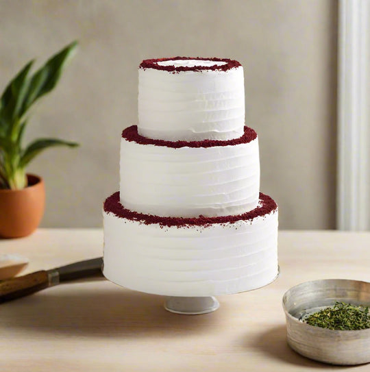 Red Velvet Wedding Cake — white cream layers with contrasting red crumb bands; India