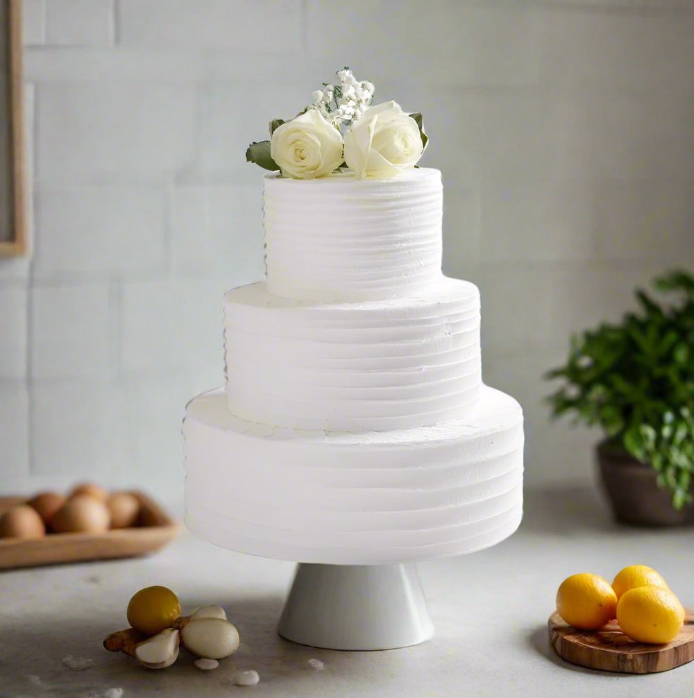 Wedding Band Cake — plain white ridged finish and pale rose topping; India